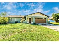 Single-story home with attached garage and lawn at 23181 Fitzpatrick Ave, Punta Gorda, FL 33980