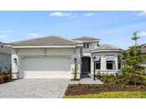 Charming single-Gathering home with a well-manicured front yard and a two-car garage at 10442 Morning Mist, Sarasota, FL 34241