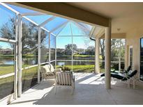 Screened-in patio features comfortable seating and tranquil lake views at 2921 Seasons Blvd, Sarasota, FL 34240