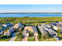 Stunning aerial view of a single-Gathering home with a tile roof and a beautiful waterfront backdrop at 5130 Tidewater Preserve Blvd, Bradenton, FL 34208