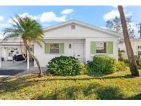 Charming single story home with carport and lush landscaping at 6010 Arlene Way, Bradenton, FL 34207