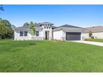 Charming one story home with lush green lawn and modern design at 2775 Pecan St, North Port, FL 34287