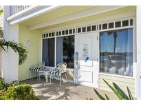 Inviting condo exterior featuring a private patio with seating for two at 611 Destiny Dr # 107, Ruskin, FL 33570