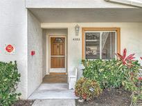 Charming front entrance featuring a decorative door, a window and lush landscaping at 4382 Madeira Ct # 3361, Sarasota, FL 34233