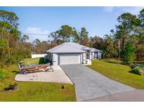 Single-story home with attached garage and boat at 14308 Tugwell Ave, Port Charlotte, FL 33953