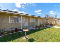 Charming ranch-style home with a landscaped front yard and bird bath at 2246 Mill Ter, Sarasota, FL 34231