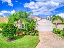 Beautiful one-story house with lush landscaping and brick driveway at 4139 63Rd E Ter, Sarasota, FL 34243