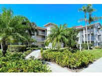 Two-story condo building with lush landscaping and walkways at 9320 Clubside Cir # 2109, Sarasota, FL 34238