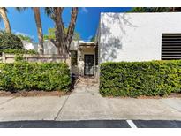 Front view of a single-story house with well-manicured hedges and a walkway at 597 Lakeside Dr, Bradenton, FL 34210