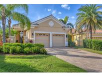 Tan two-car garage house with landscaping at 7116 Presidio Gln, Lakewood Ranch, FL 34202