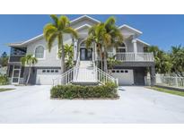Two-story home with white siding and palm trees at 6317 Werner Ave, New Port Richey, FL 34652