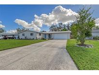 Ranch-style home with a two-car garage and landscaped yard at 3442 Fairview Dr, Sarasota, FL 34239