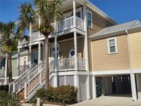 Two story home with front porch and attached garage at 11776 Angler'S Club Dr, Placida, FL 33946