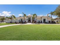 Modern house with palm trees and manicured lawn at 6817 Riverview Blvd, Bradenton, FL 34209