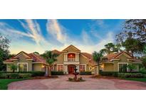 Grand two-story home with circular drive and fountain at 854 Macewen Dr, Osprey, FL 34229