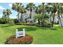 Lakes of Capri building entrance with lush landscaping at 1100 Capri Isles Blvd # 523, Venice, FL 34292