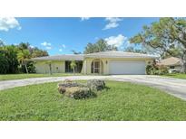 Single-story home with a large yard and attached garage at 134 Da Vinci Dr, Nokomis, FL 34275