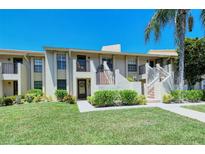 Two story condo building with lush landscaping at 4416 Weybridge # 90, Sarasota, FL 34235