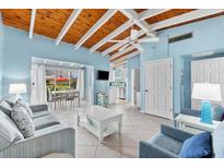 Bright living room with light blue walls and vaulted ceilings at 6006 Midnight Pass Rd # 8, Sarasota, FL 34242