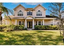 Two-story house with a large front yard and double-door entry at 14106 18Th E Pl, Bradenton, FL 34212
