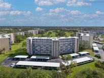 Aerial view of a large apartment building with parking and green space at 3660 Ironwood Cir # 101M, Bradenton, FL 34209