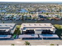 Stunning aerial view of a waterfront condo community with boat docks and lush landscaping at 4452 Garnet Dr # 205, New Port Richey, FL 34652