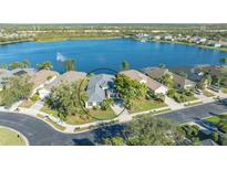 Aerial view of single-story home on lake, showcasing the property and surrounding landscape at 7407 Sea Island Ln, Bradenton, FL 34201