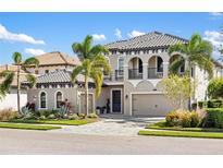 Two-story home with attractive landscaping and a three-car garage at 7634 Windy Hill Cv, Bradenton, FL 34202