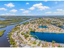 Stunning aerial view of waterfront home, showcasing landscaping and waterfront access at 1228 50Th E St, Bradenton, FL 34208