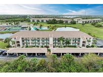 Aerial view of condo building with parking and amenities at 175 Kings Hwy # B-2, Punta Gorda, FL 33983