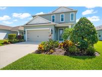 Two-story house with a two-car garage and well-manicured lawn at 4704 Foxtail Dr, Parrish, FL 34219