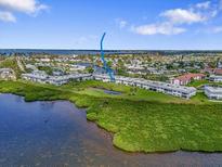 Aerial view of waterfront condos with a canal and lush green landscaping at 4737 Independence Dr # 4737, Bradenton, FL 34210