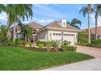 Well-maintained house with a stone facade and manicured lawn at 7139 Sandhills Pl, Lakewood Ranch, FL 34202