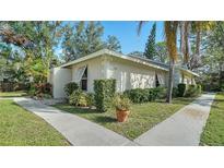 Light beige house with shutters, landscaping, and a walkway, offering curb appeal at 766 N Jefferson Ave # 766, Sarasota, FL 34237