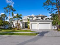 Two-story house with white siding, three-car garage, and landscaped front yard at 1516 S Orange Ave, Sarasota, FL 34239