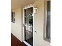 Condo front door entrance with storm door at 3751 S School Ave # 29, Sarasota, FL 34239