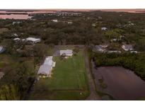Sprawling property featuring lush greenery, waterfront views, and multiple structures at 1640 Center Rd, Terra Ceia, FL 34250