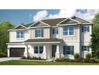 Two-story home with a large front yard and attached garage at 16435 Star Grass Cir, Bradenton, FL 34211