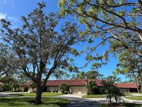 Exterior view of home with red tile roof and landscaping at 3711 Pinecone Ct # 168, Sarasota, FL 34238