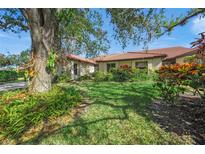 Landscaped front yard with mature trees at 4573 Pine Green Trl # 1, Sarasota, FL 34241