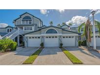 Two-story house with a double garage and lush landscaping at 1328 Siesta Bayside Dr # 1328-C, Sarasota, FL 34242