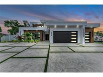 Modern home showcasing an elegant driveway, lush landscaping, and contemporary design at 2038 Datura St, Sarasota, FL 34239