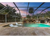 Relaxing pool and spa area with waterfall feature and lounge chairs at 2501 Broad St, Nokomis, FL 34275