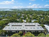Beautiful aerial view of the property showcasing lush landscaping and nearby waterway at 3700 S Osprey Ave # 214, Sarasota, FL 34239