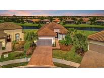 Luxury home with a tile roof and nicely landscaped yard at 4612 Stickley Ct, Palmetto, FL 34221