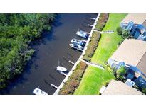 Aerial view of boat docks and waterway access with adjacent condominiums and green space at 8706 54Th W Ave # 18, Bradenton, FL 34210