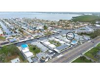 Aerial view of waterfront community with multiple buildings and a pool at 9717 Santa Maria Ct, Bradenton, FL 34210