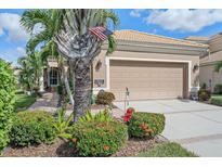 House exterior with a two-car garage and landscaping at 6023 Wingspan Way, Bradenton, FL 34203