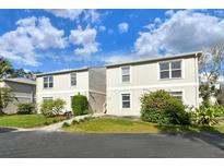 Two-story building exterior with landscaping and parking at 381 Bobby Jones Rd # 381, Sarasota, FL 34232