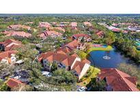 Aerial view of building near lake and tennis courts at 4134 Central Sarasota Pkwy # 1734, Sarasota, FL 34238